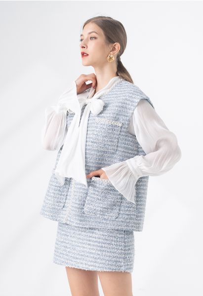 Veste sans manches en tweed avec poche à bord nacré en bleu