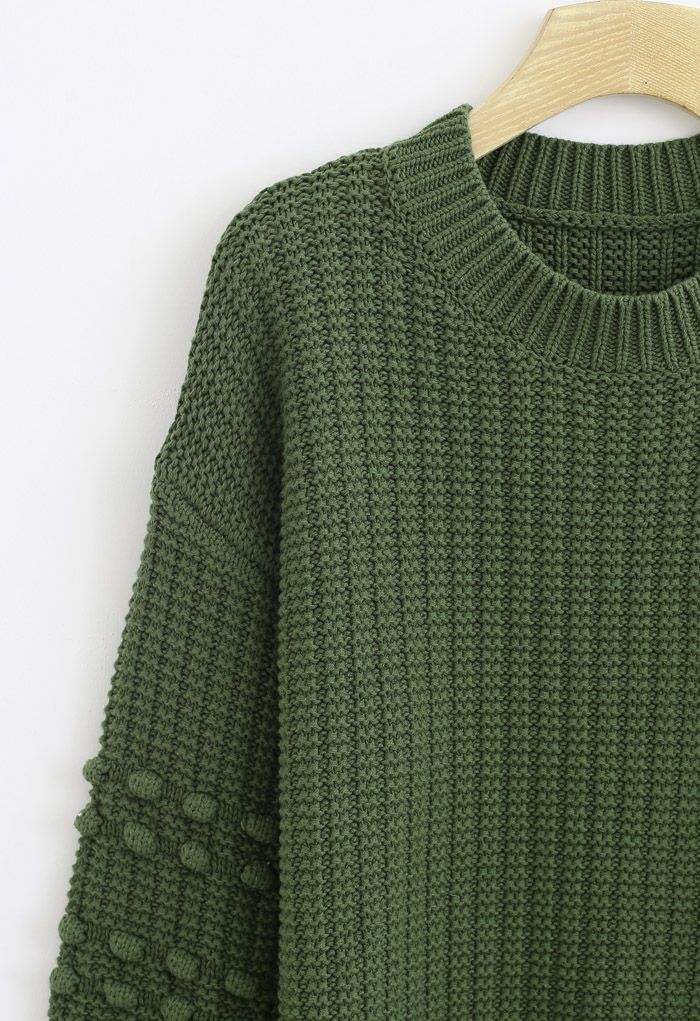 Pull à manches boules avec pompons en vert