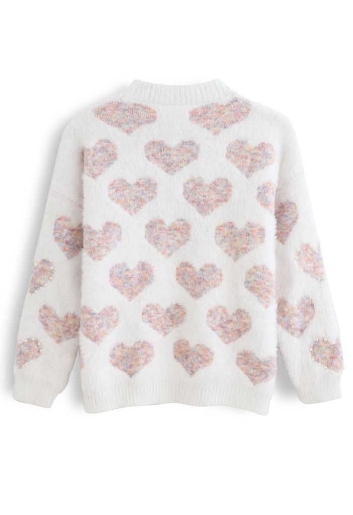 Pull en maille rose floue avec cœur et perles