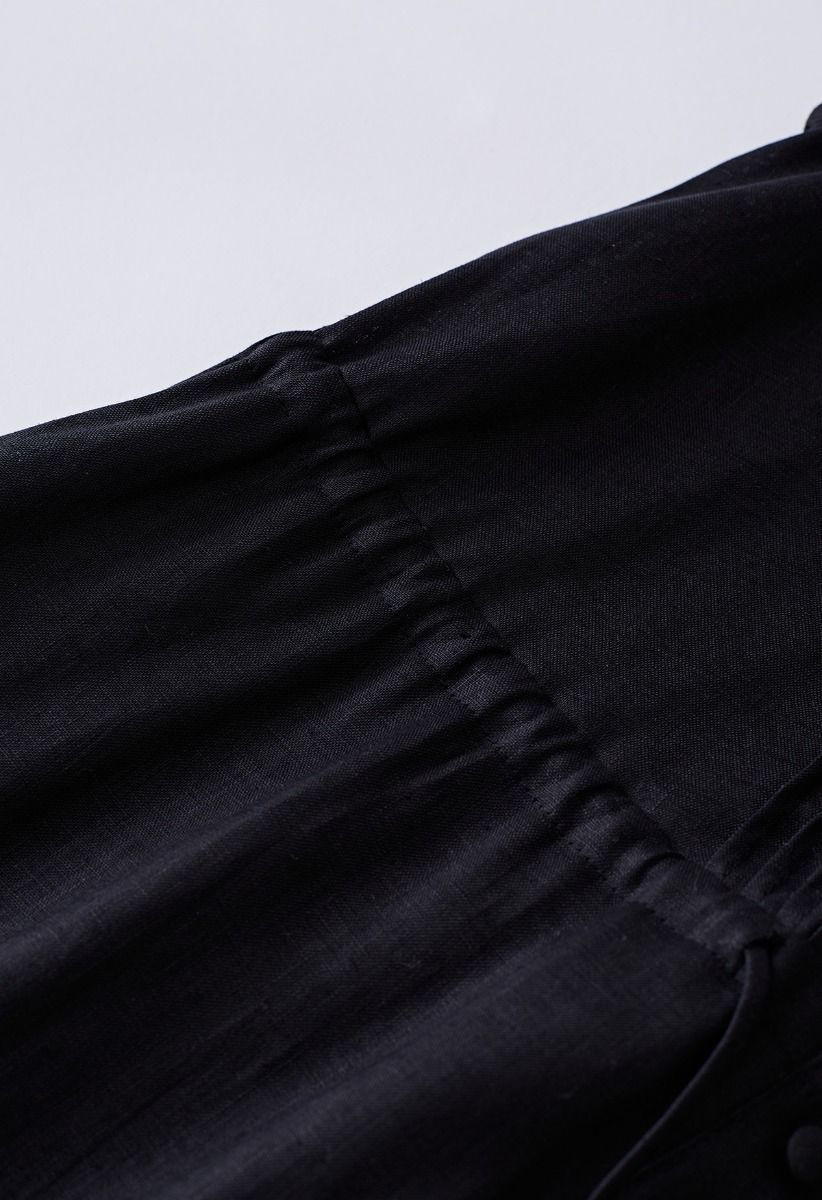 Robe sans manches boutonnée à col en V en noir